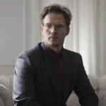 well dressed businessman sitting on sofa